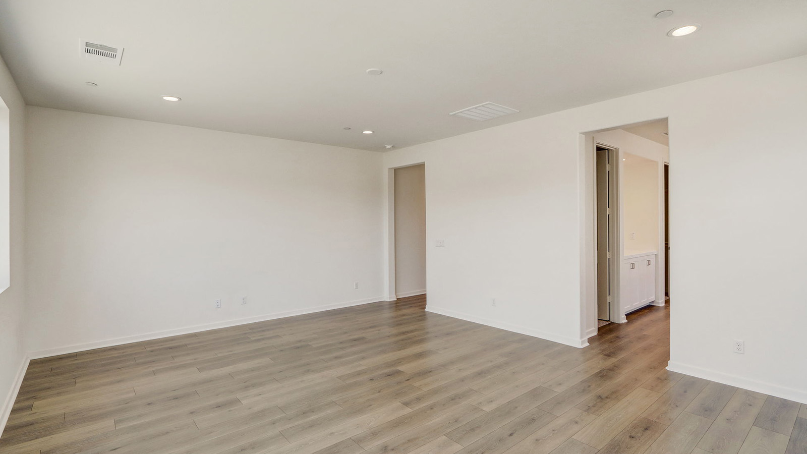 Primary bedroom with laminate flooring