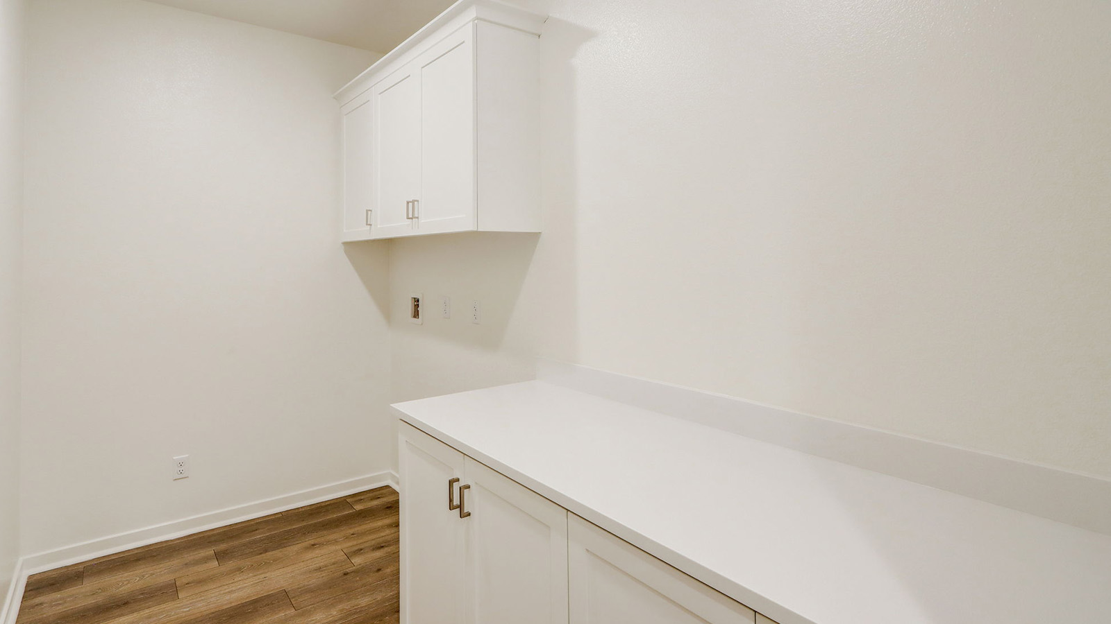 Laundry room with upper and lower cabinets and washer and dryer