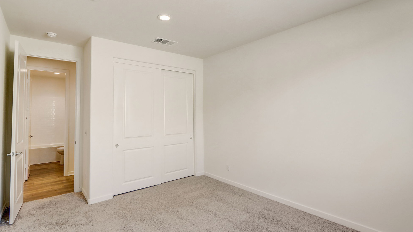 Secondary bedroom with carpet