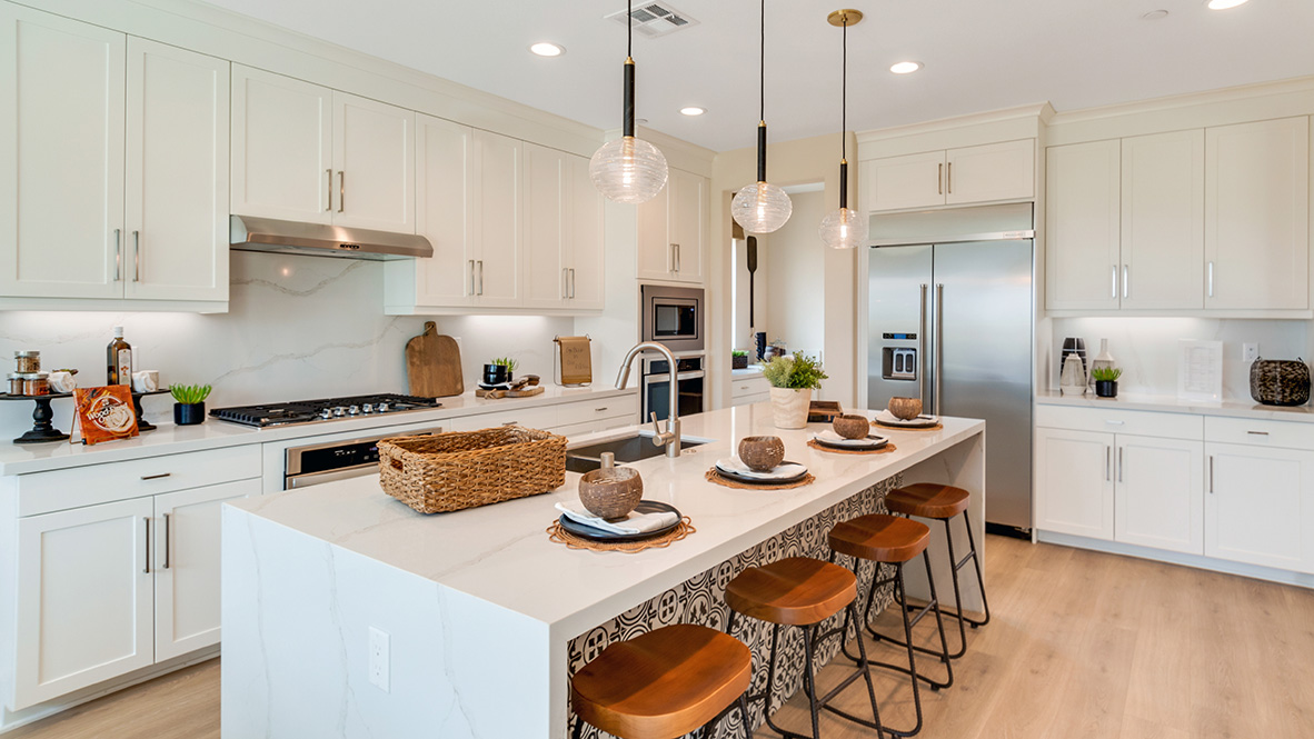 Kitchen with white cabinets quartz countertops and stainless steel appliances