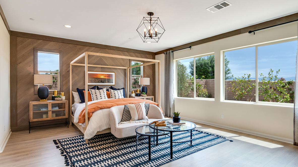 Primary bedroom with king bed and laminate flooring