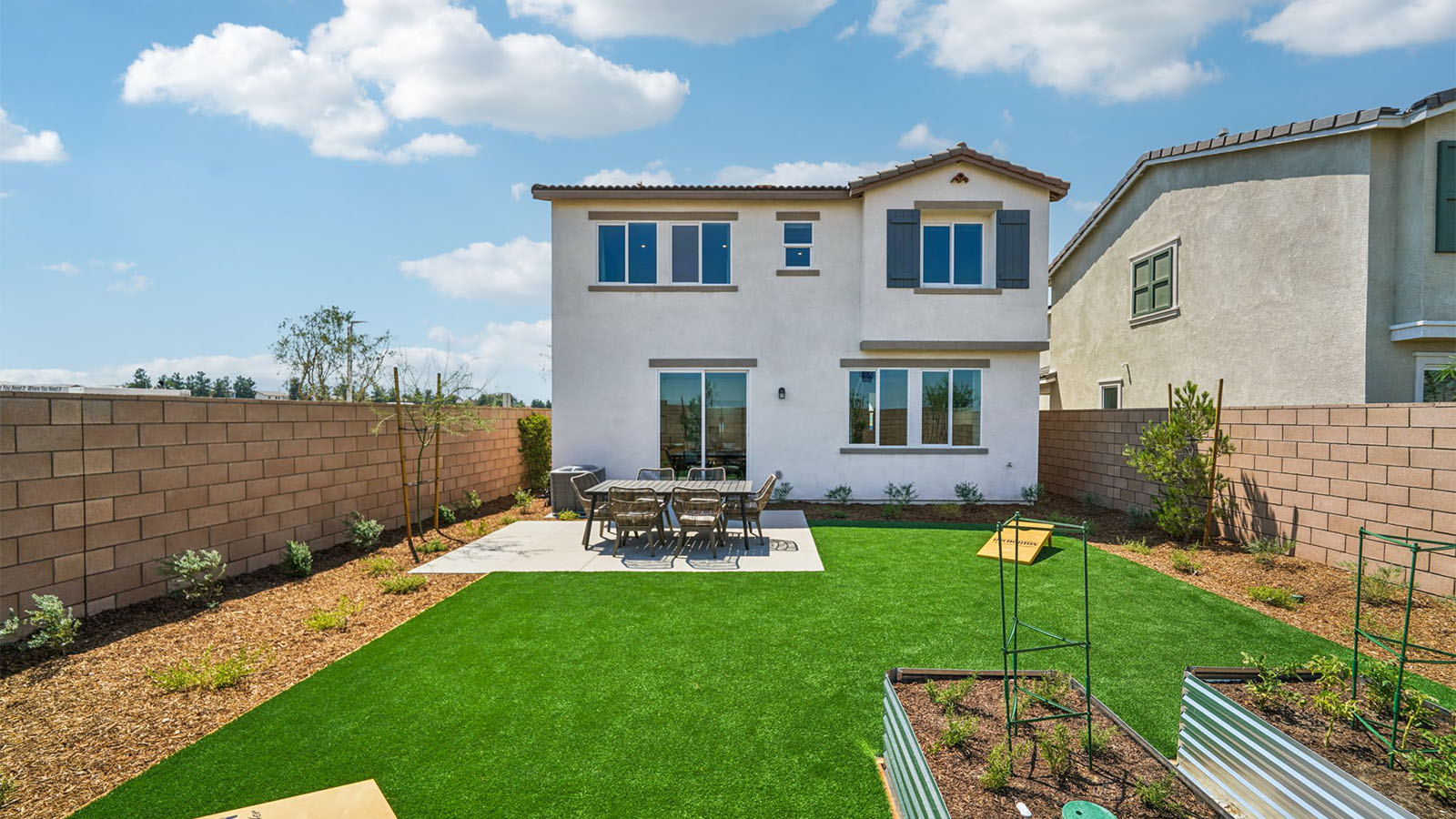 Spacious backyard with patio area and outdoor furniture