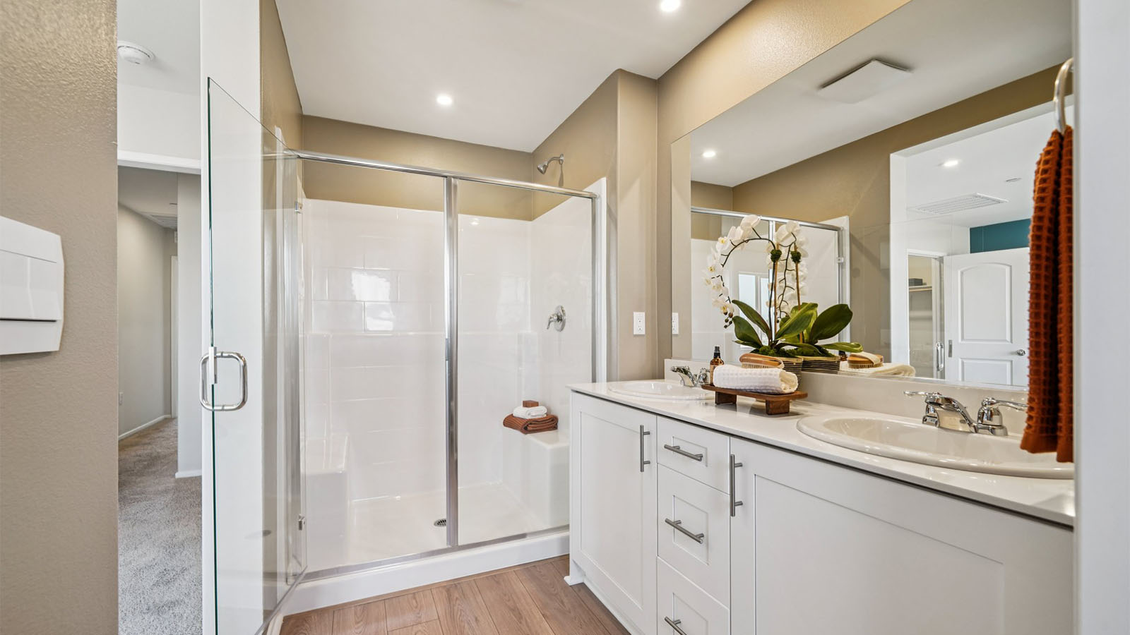 Primary bathroom with dual sinks and shower