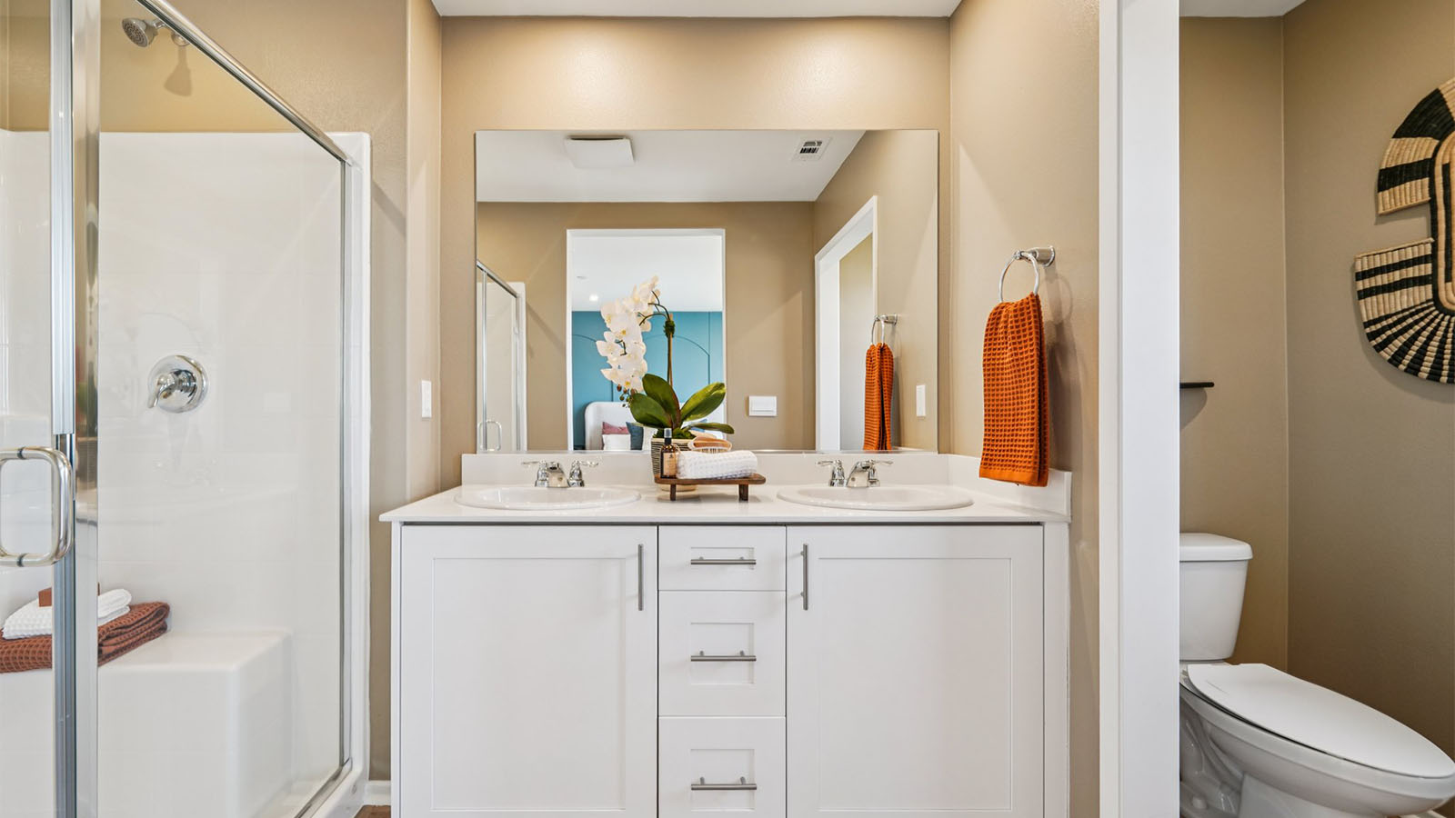 Primary bathroom with dual sinks and shower
