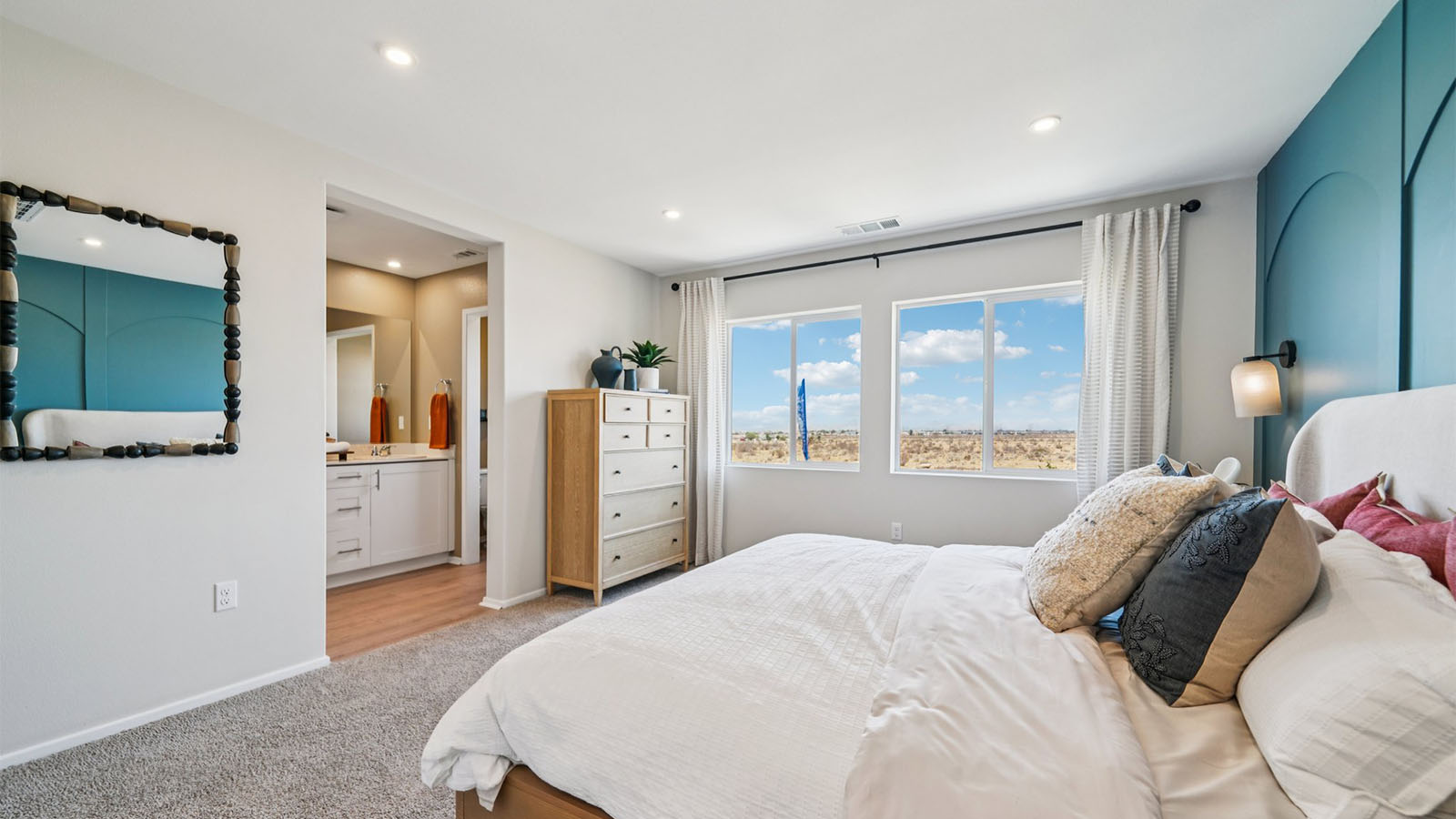 Primary bedroom with king bed with plush carpet