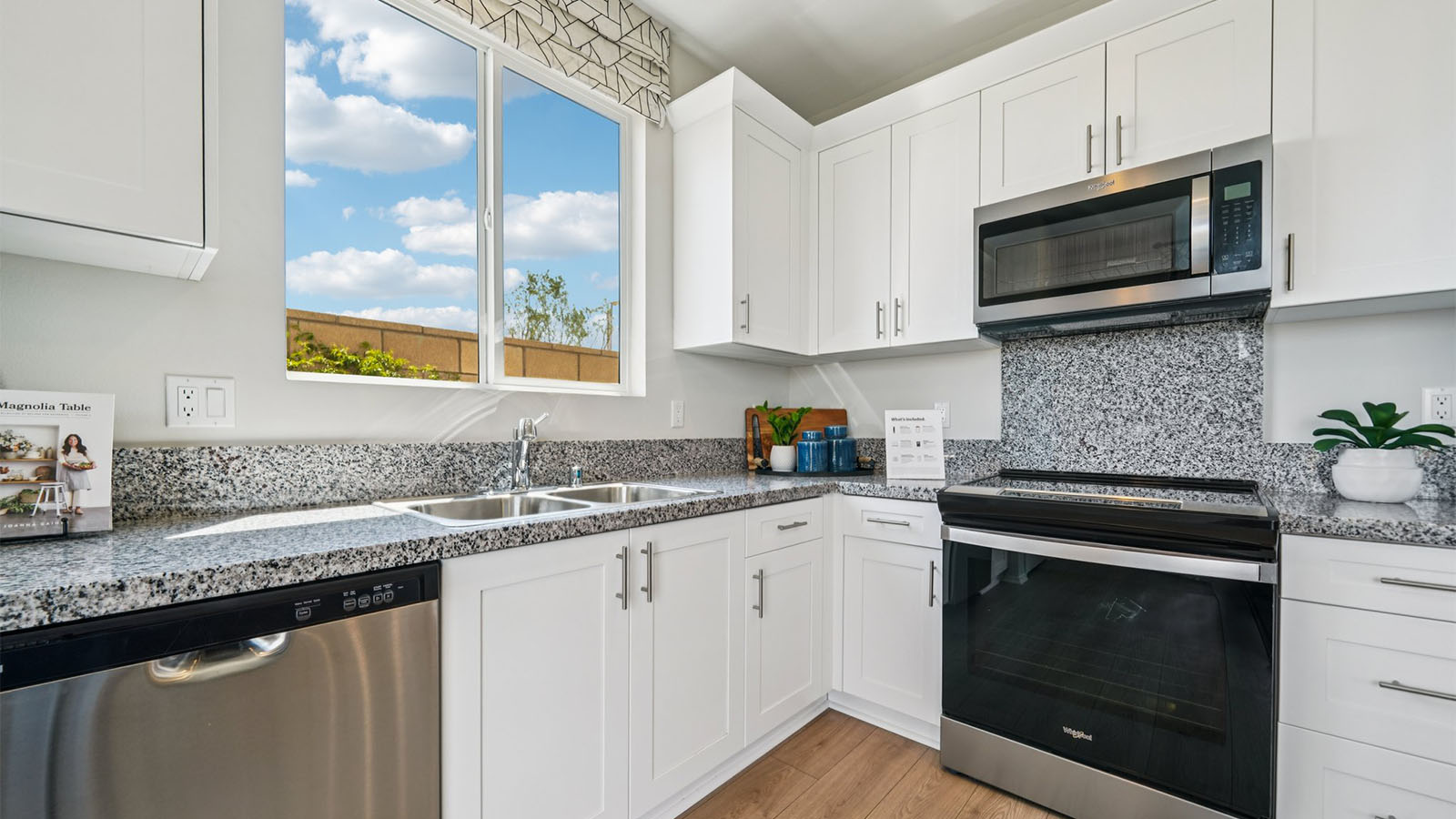 Modern open-concept kitchen area with granite countertops
