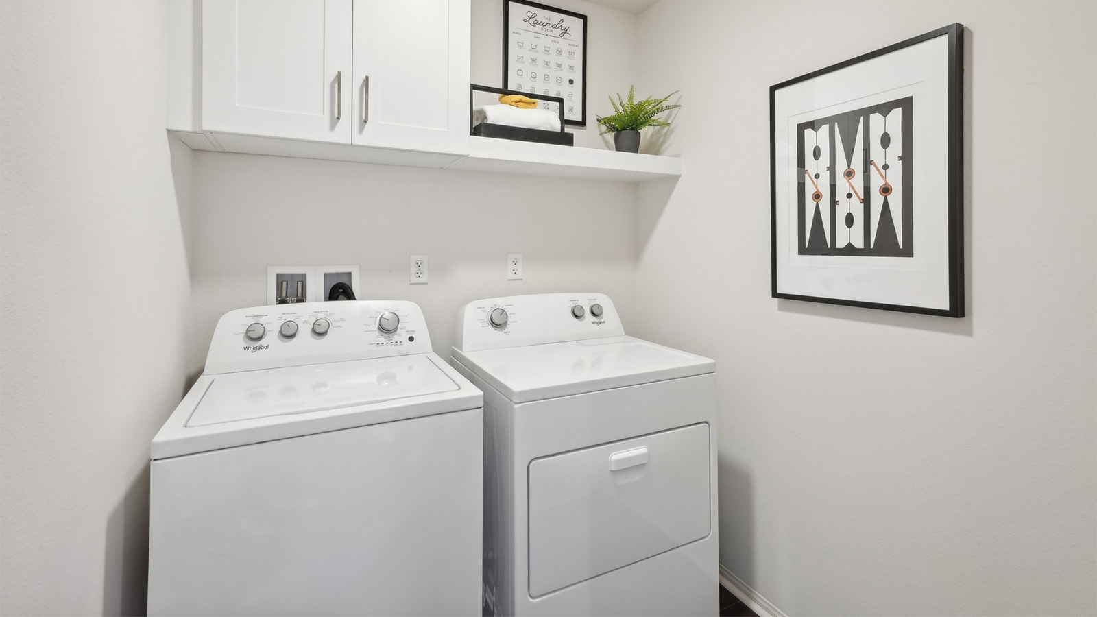 Laundry room, washer and dyer with a upper cabinet and shelf