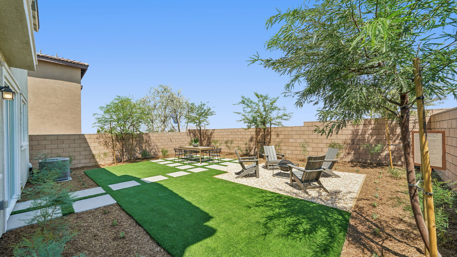 Spacious backyard with patio area and outdoor furniture
