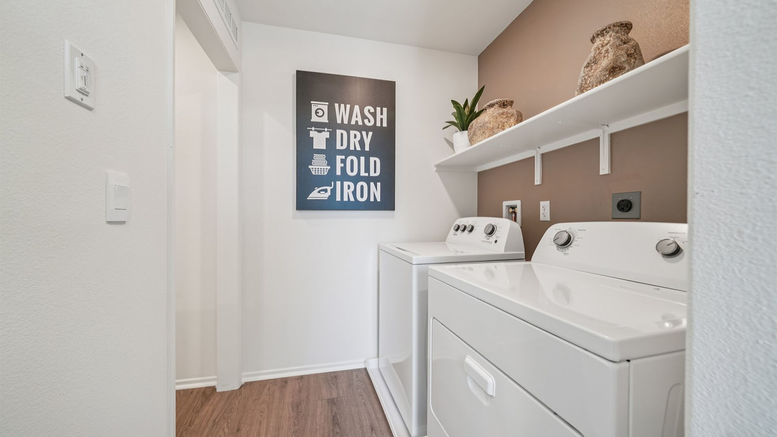 Laundry room with upper shelving