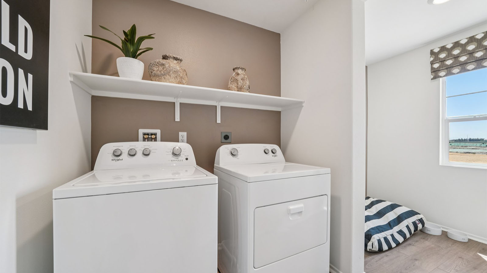 Laundry room with upper shelving