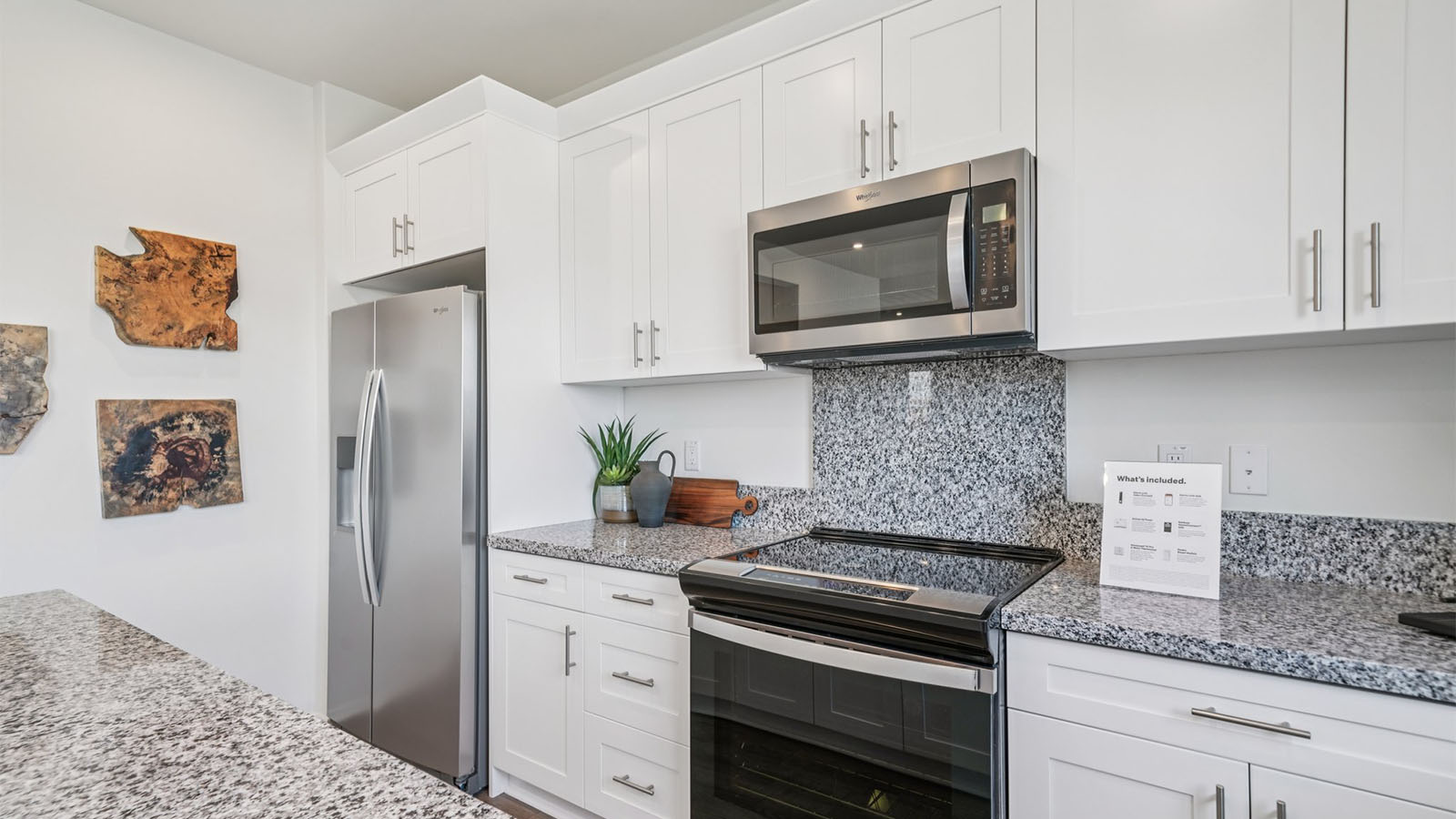 Open-concept kitchen area with granite countertops