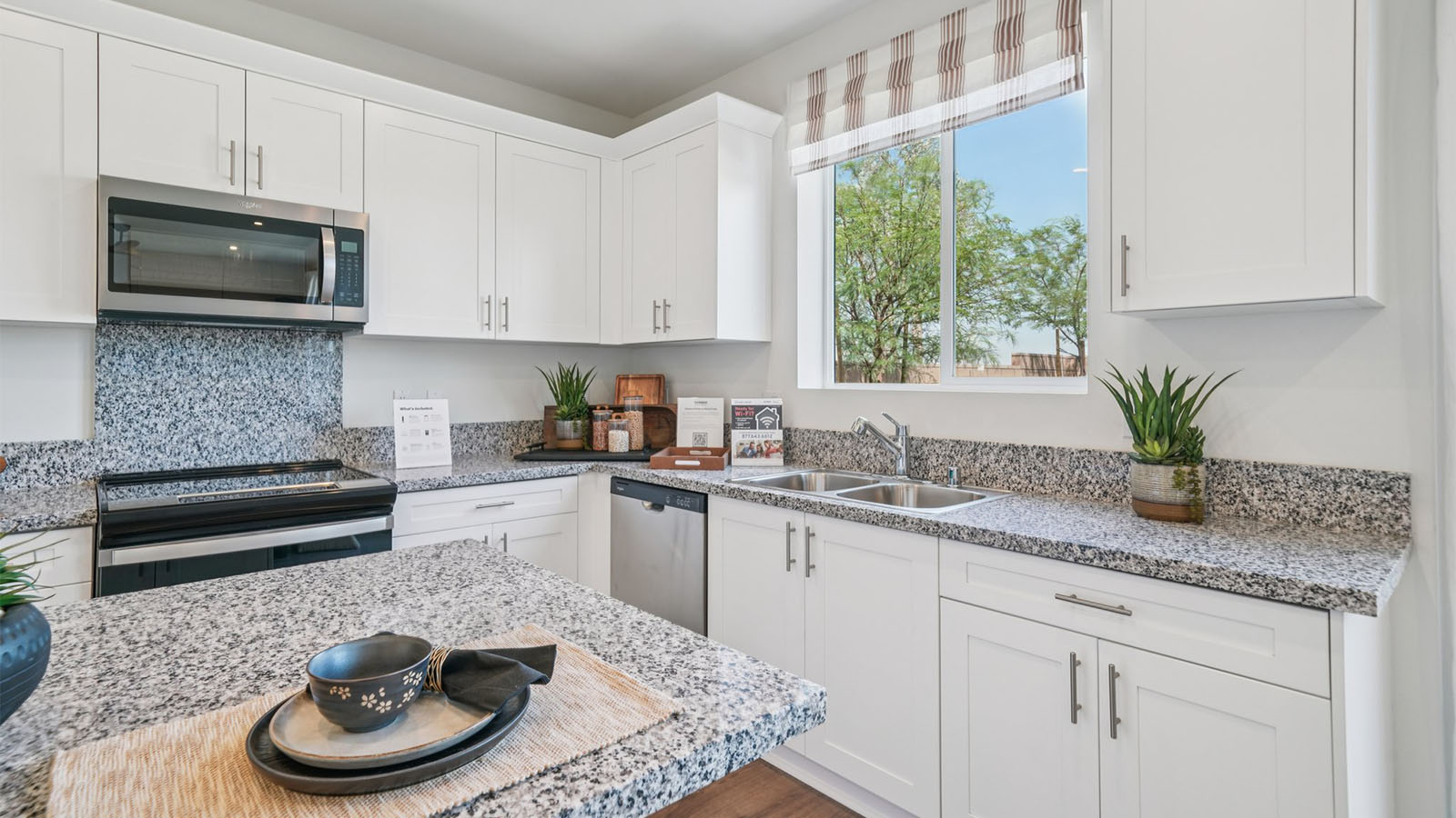Open-concept kitchen area with granite countertops