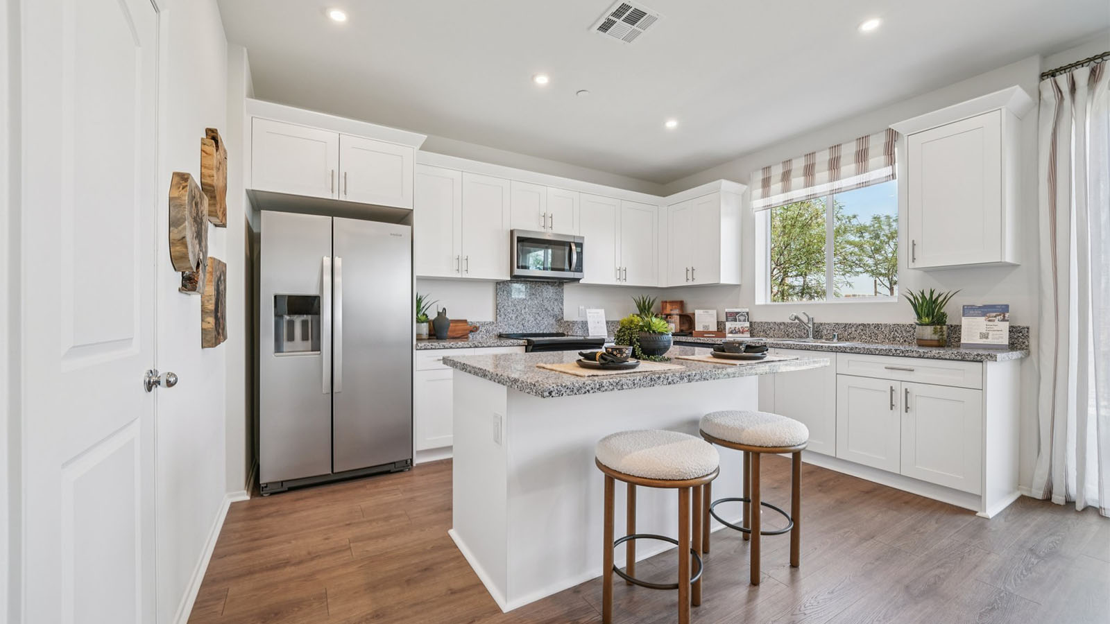 Modern open-concept kitchen area with granite countertops
