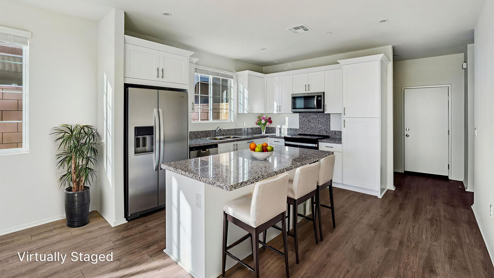 Kitchen with granite countertops and white cabinets