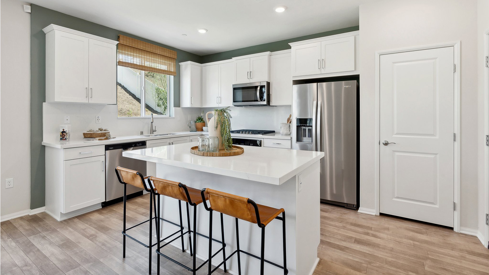 Modern kitchen with white cabinets and stainless-steel appliances
