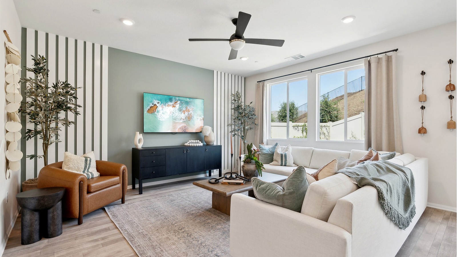 Great room seating area with large windows overlooking the patio