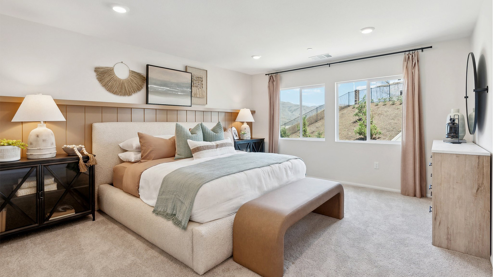 Primary bedroom with large windows looking into backyard