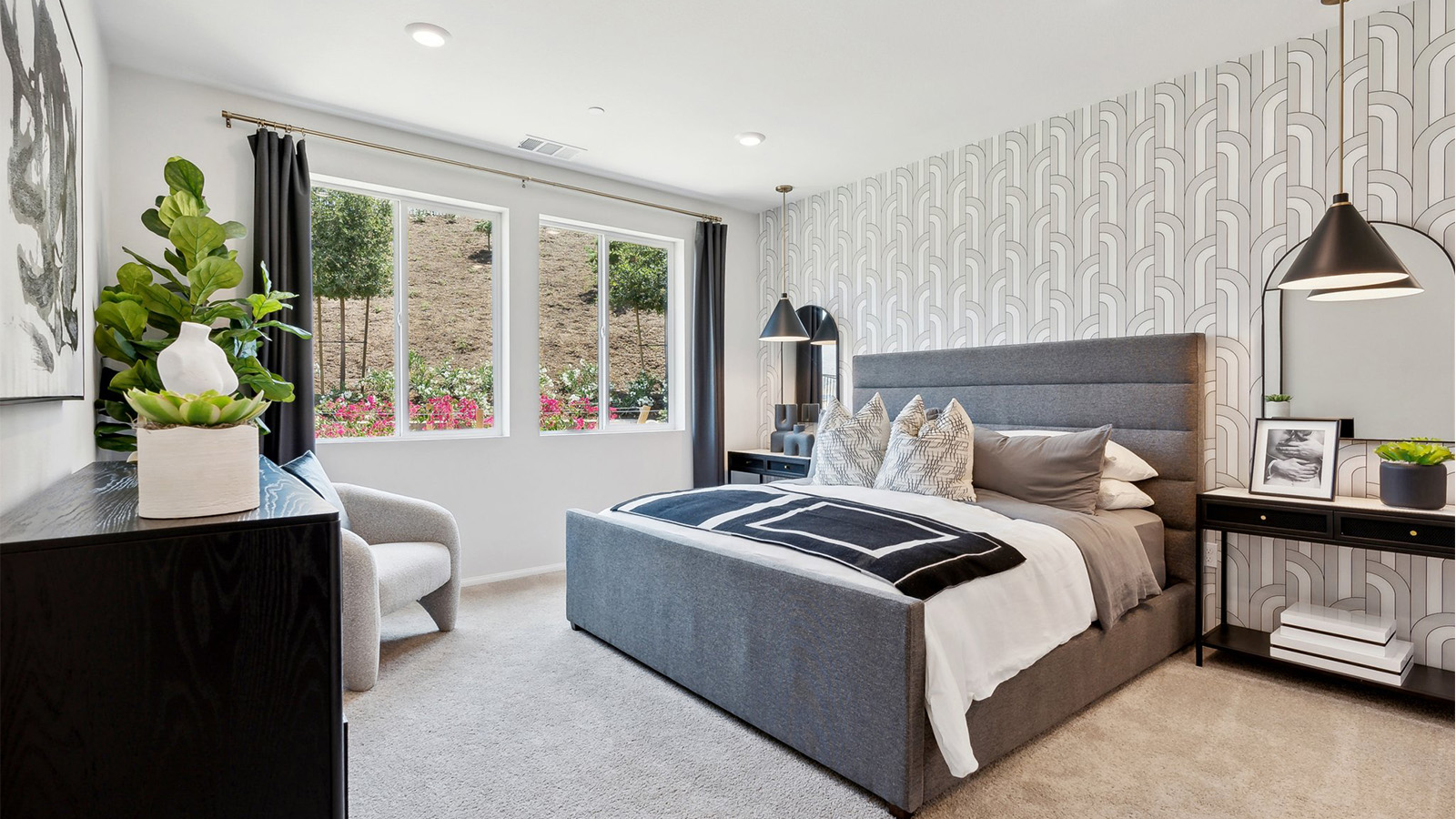 Primary bedroom with large windows looking into the backyard