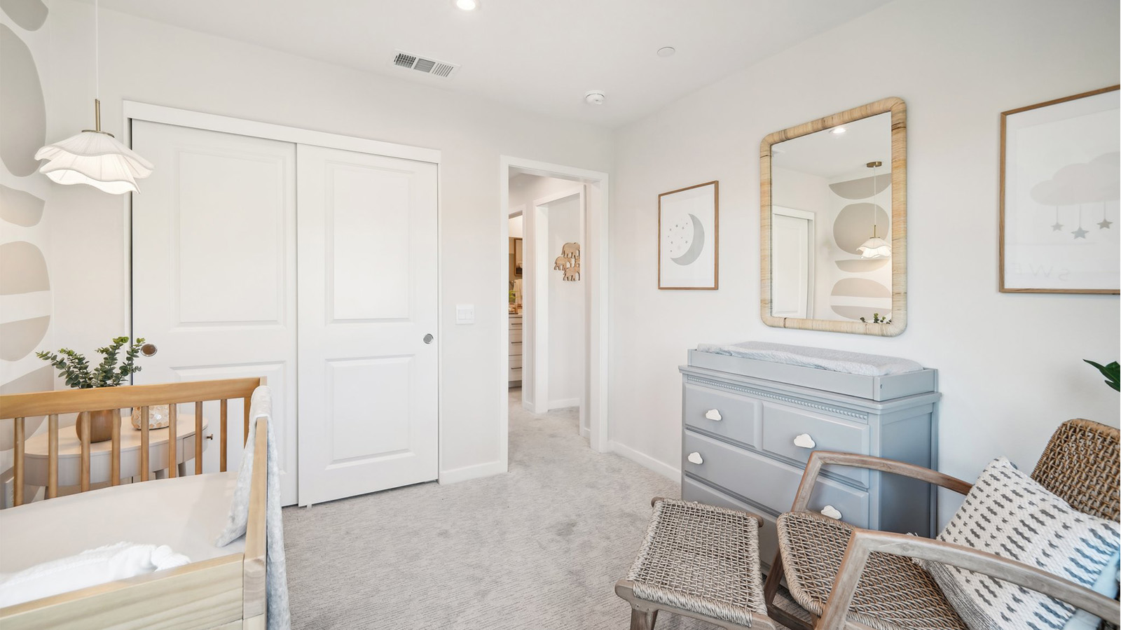 Secondary bedroom with crib and rocking chair