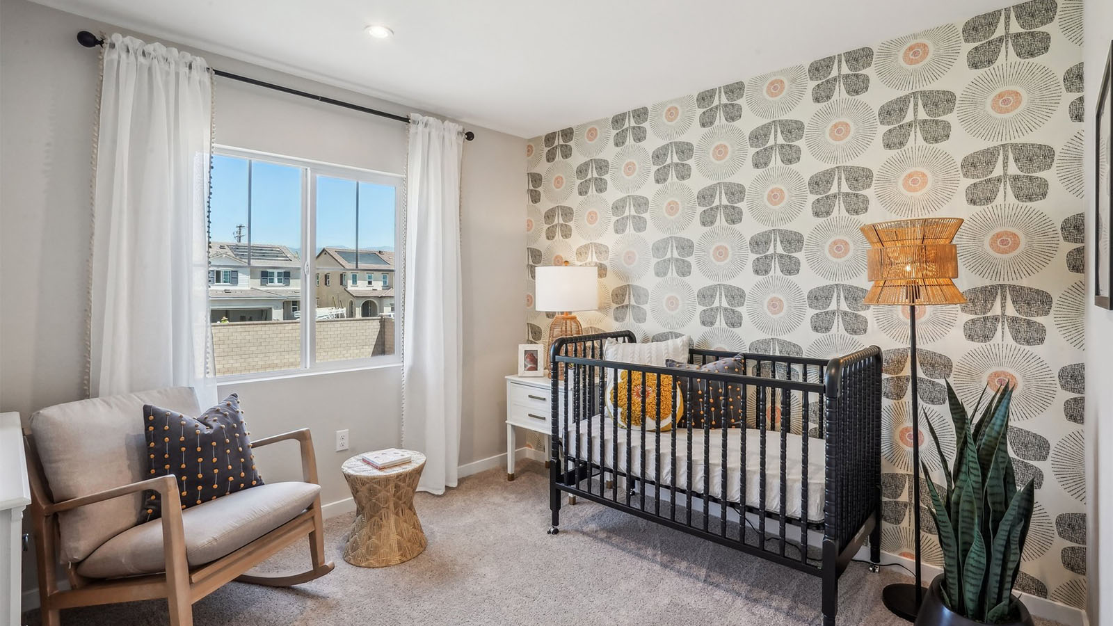 Secondary bedroom with crib and rocking chair