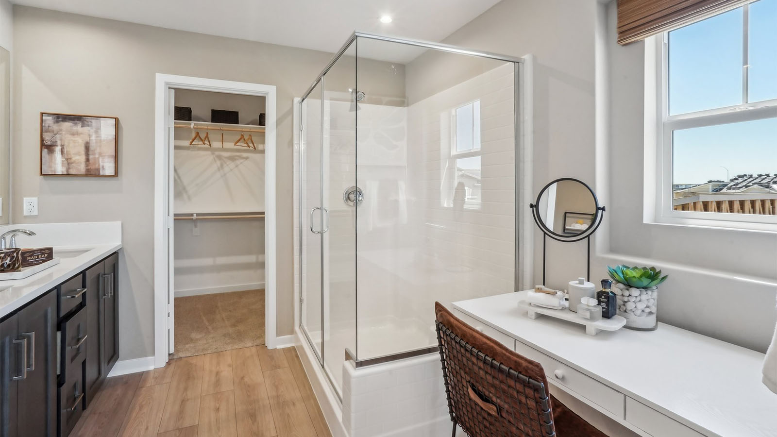 Primary bathroom with dual vanities and shower