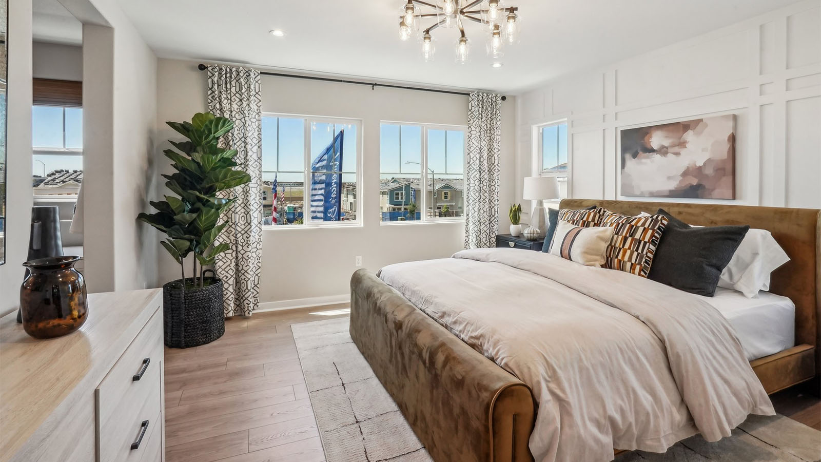 Primary bedroom with king bed and laminate flooring