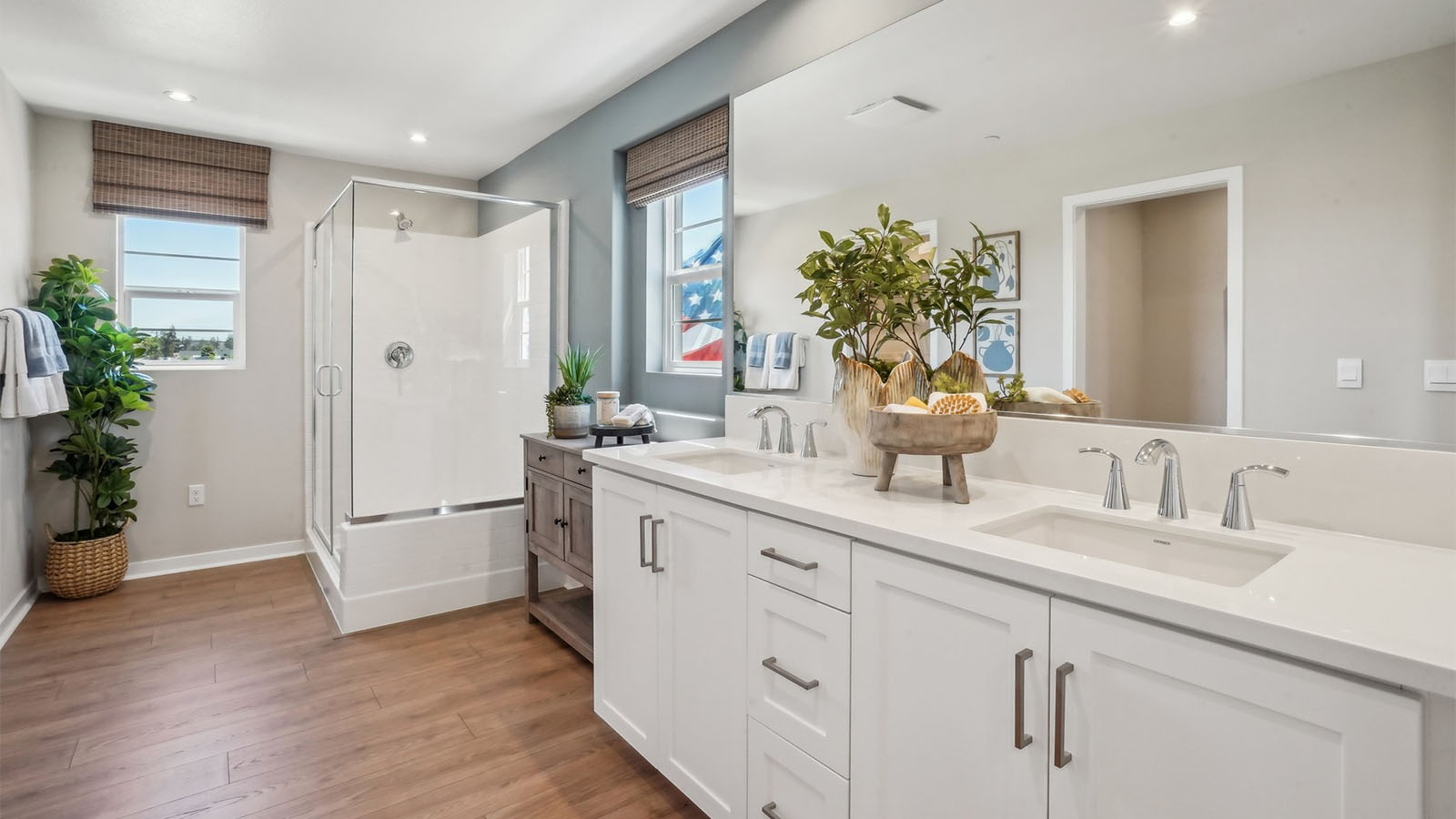 Primary bathroom with dual vanities and shower
