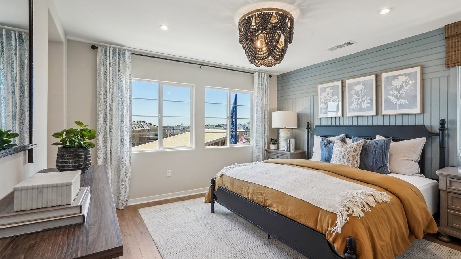 Primary bedroom with king bed and laminate flooring