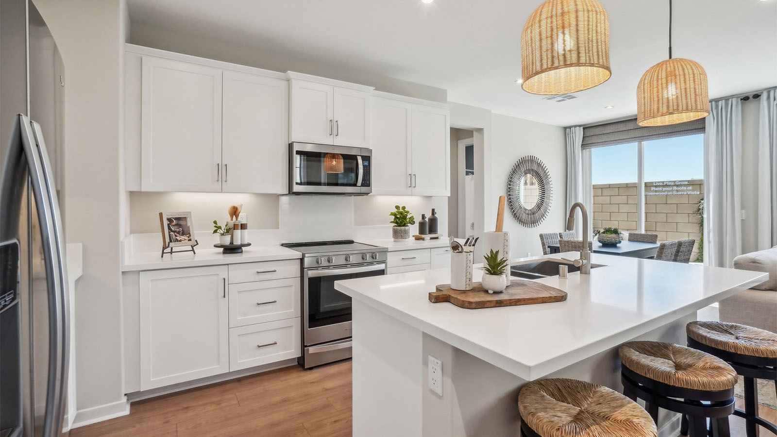 Modern kitchen with white cabinets quartz countertops and stainless steel appliances