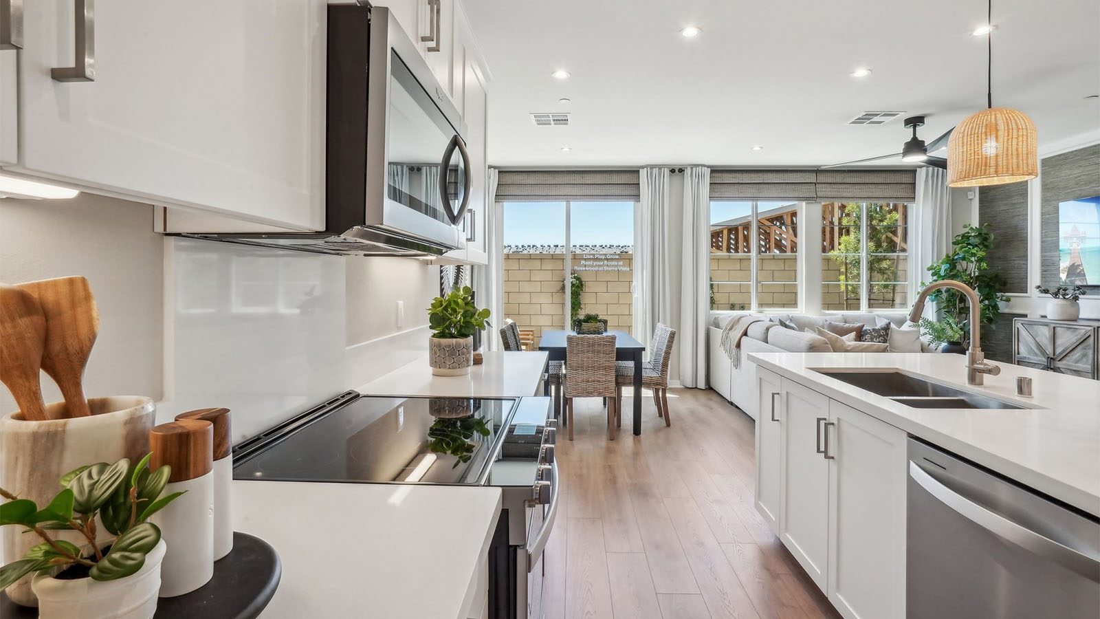 Modern kitchen with white cabinets quartz countertops and stainless steel appliances