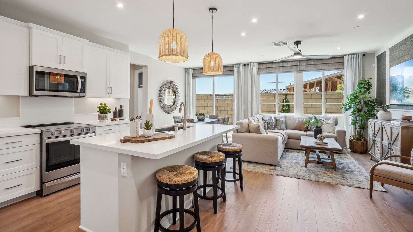 Modern kitchen with white cabinets quartz countertops and stainless steel appliances