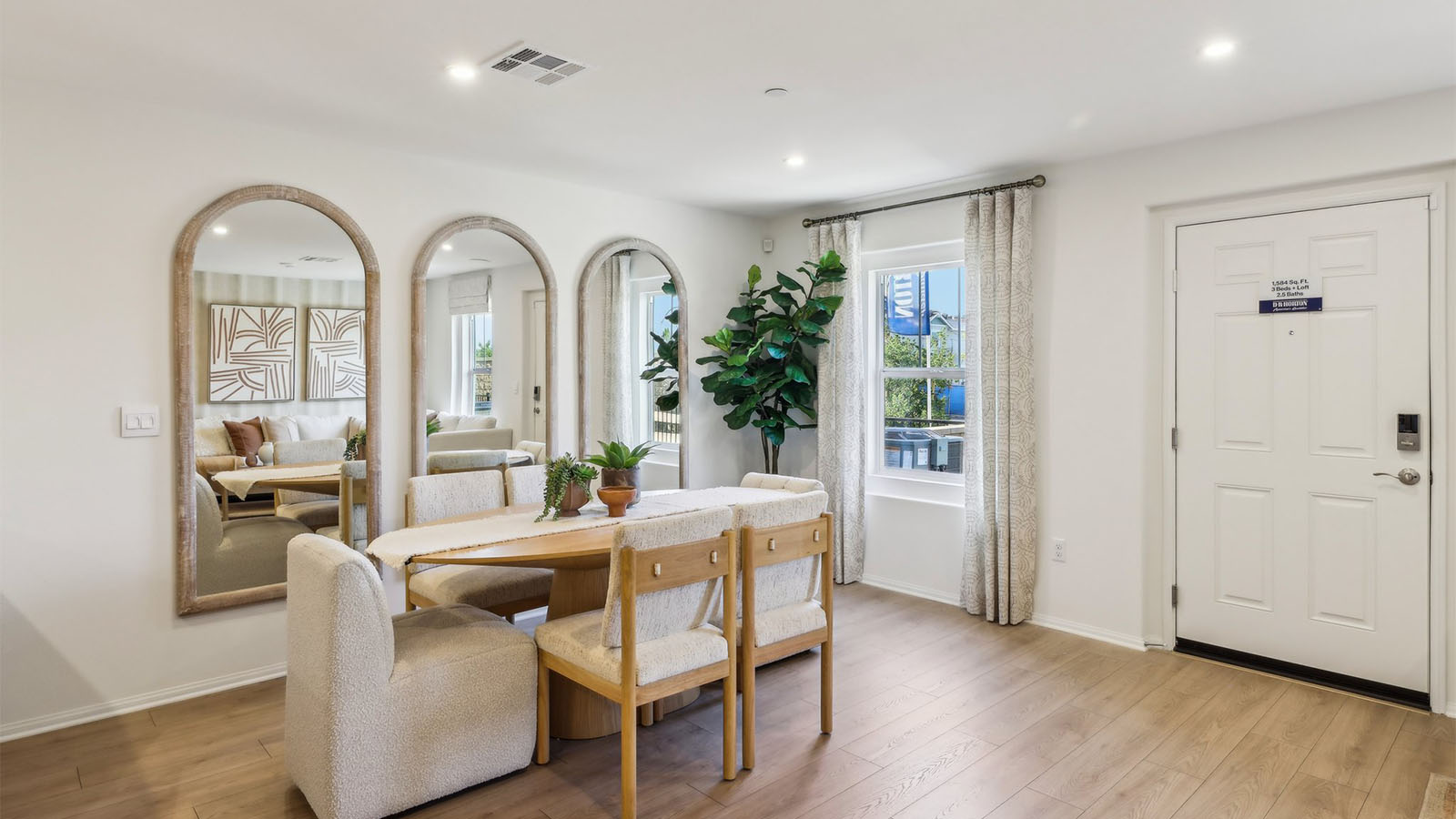 Open-concept dining room area with entry door