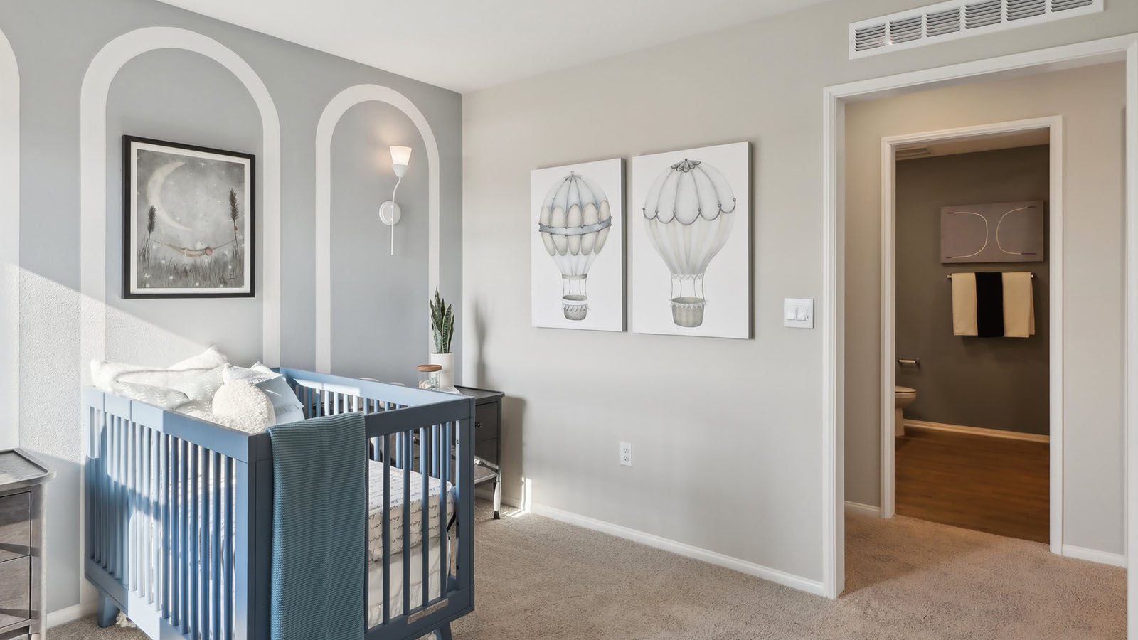 Nursery with crib, dresser, and accent wall