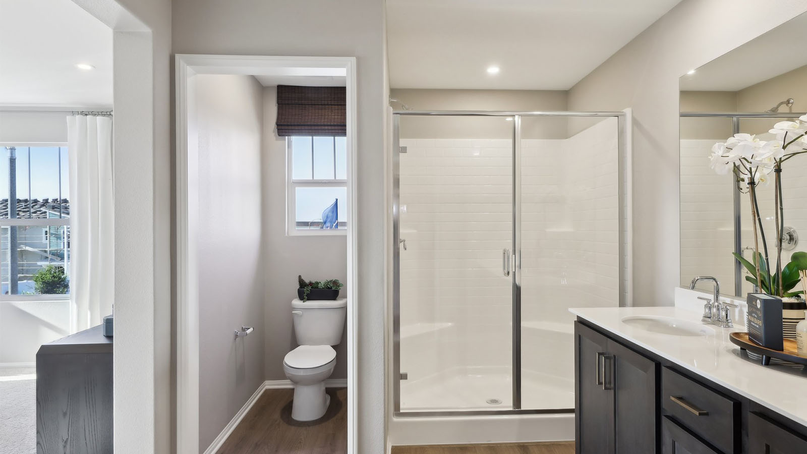 Primary bathroom with dual sinks and shower