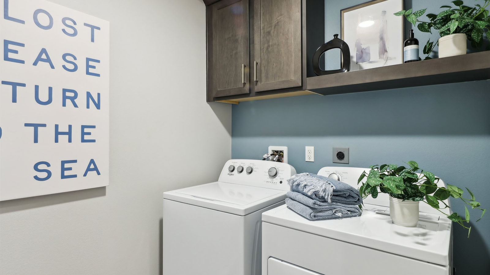 Laundry room with upper brown cabinet ad shelve