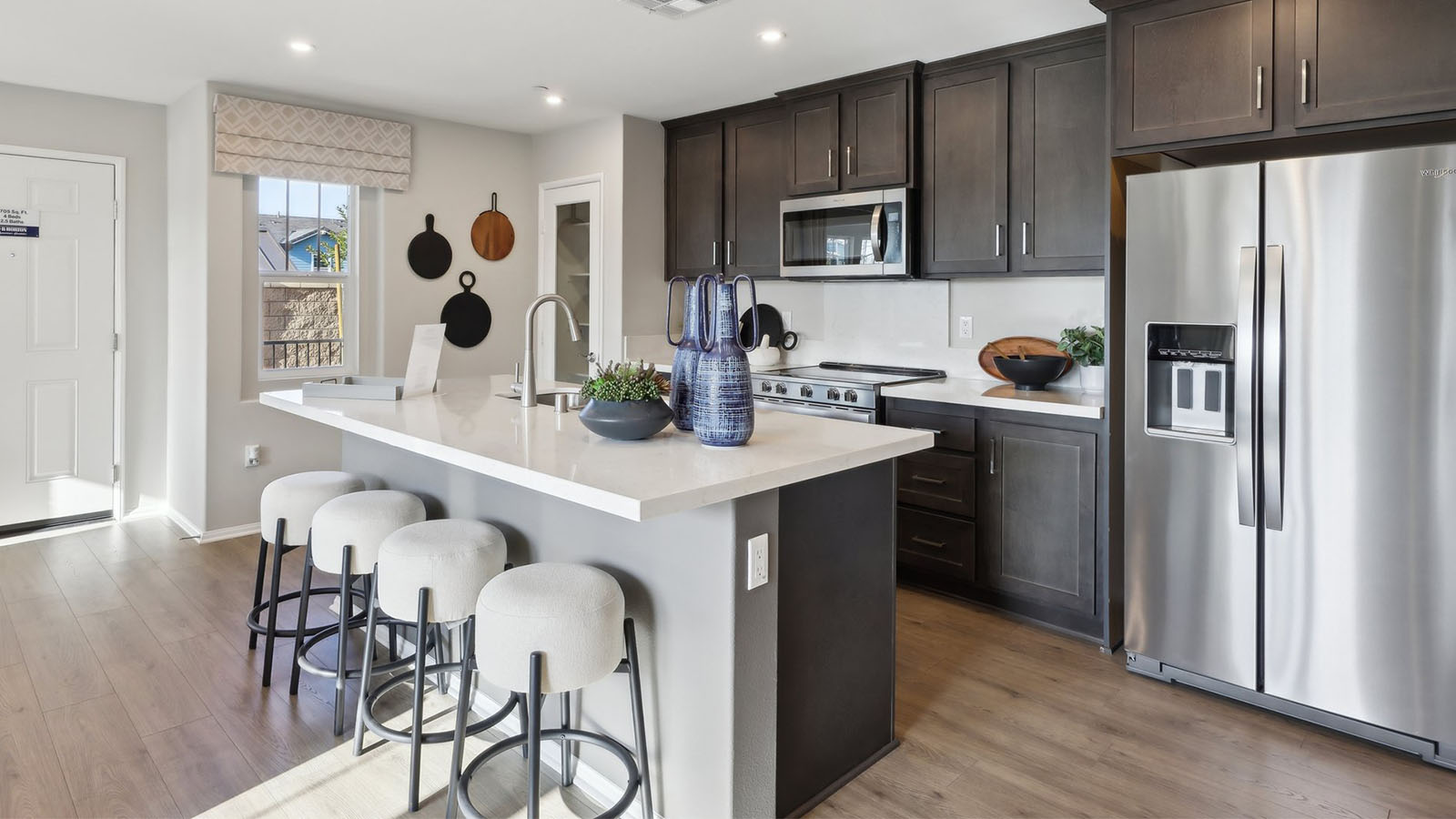 Open-concept kitchen with brown cabinets and island