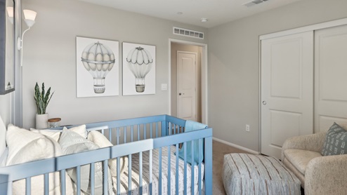 Nursery with crib, dresser, and accent wall