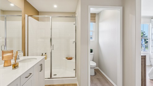 Secondary bathroom with dual sinks and shower