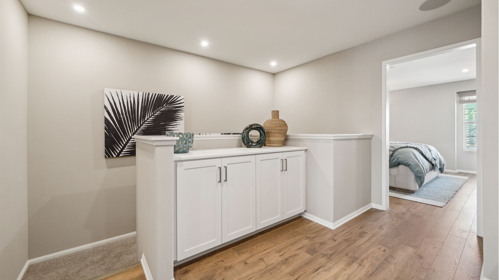 Upstairs loft area with built-in white cabinets
