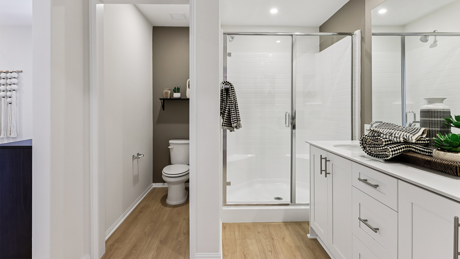 Primary bathroom with white cabinets and double sinks