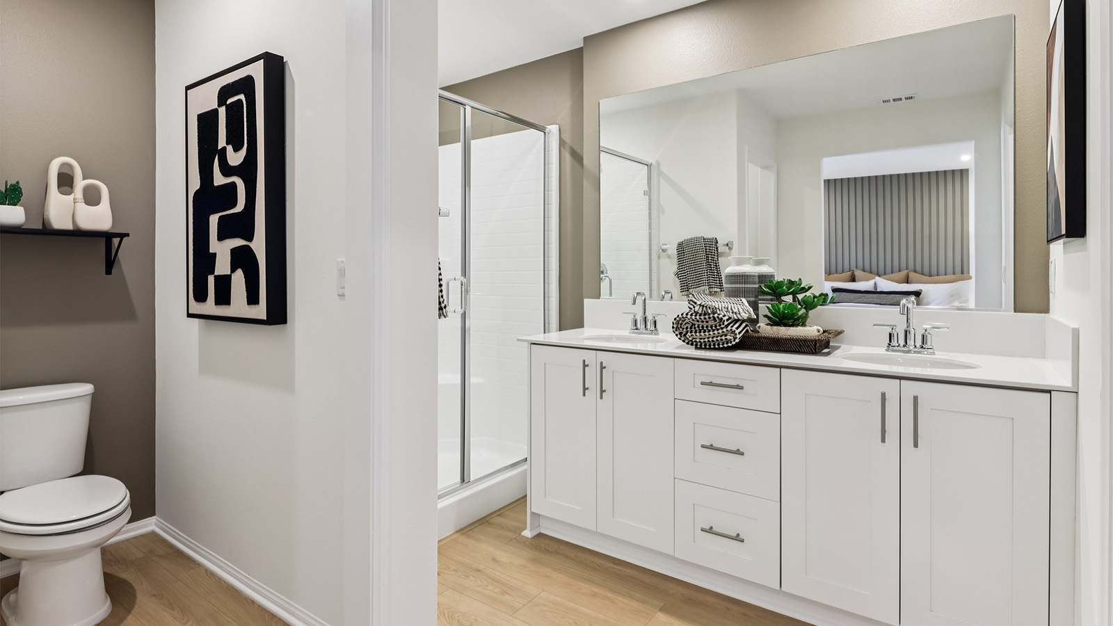 Primary bathroom with white cabinets and double sinks