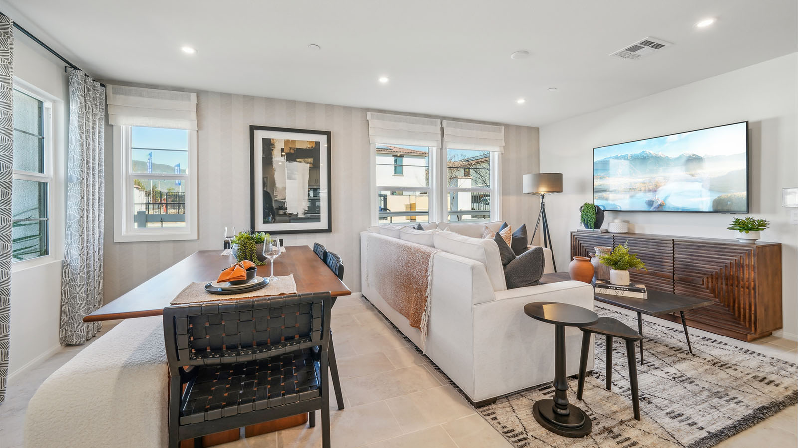 Open-concept dining and great room with accent wall