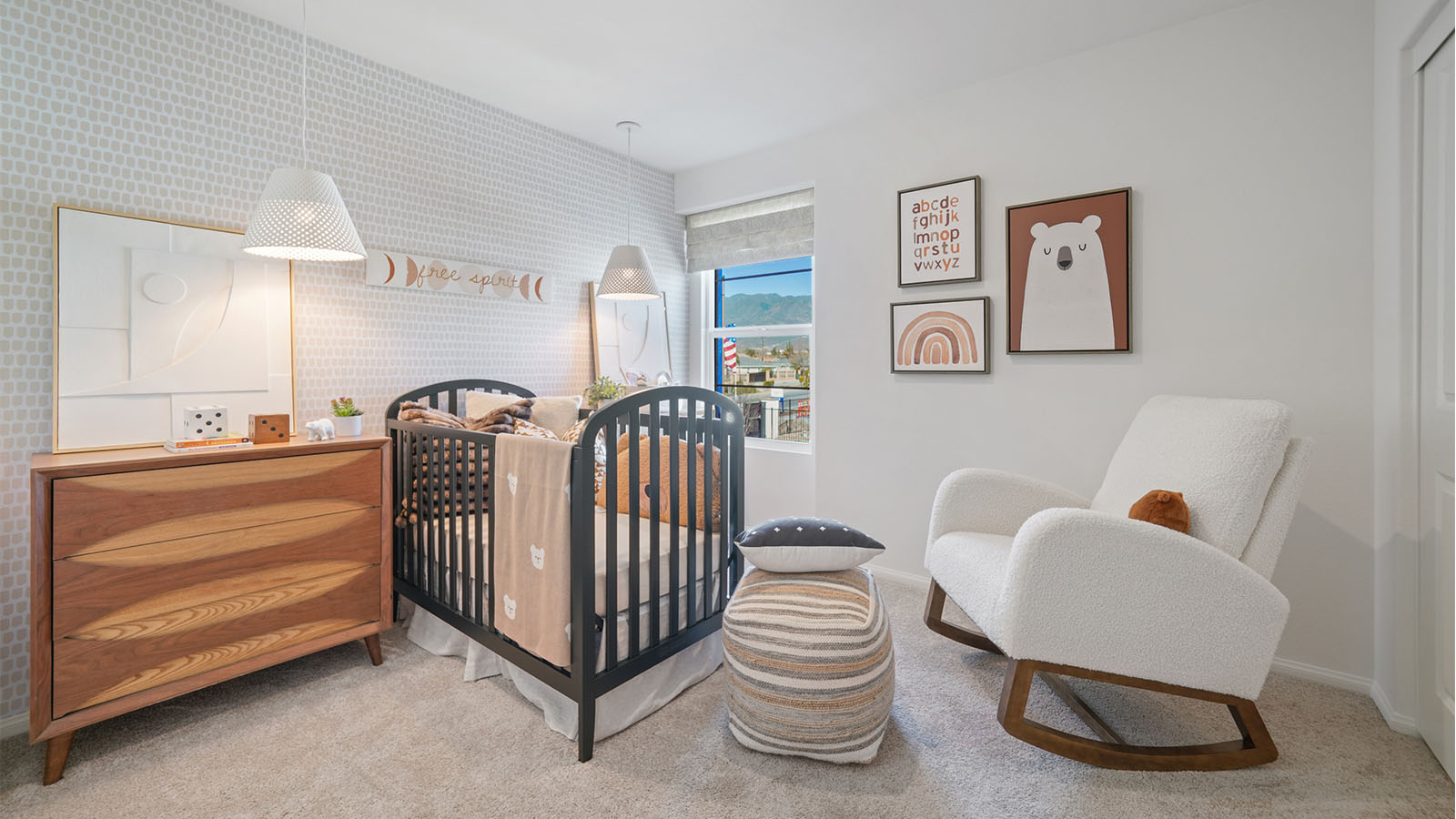 Beautiful nursery with accent wall and plush carpet