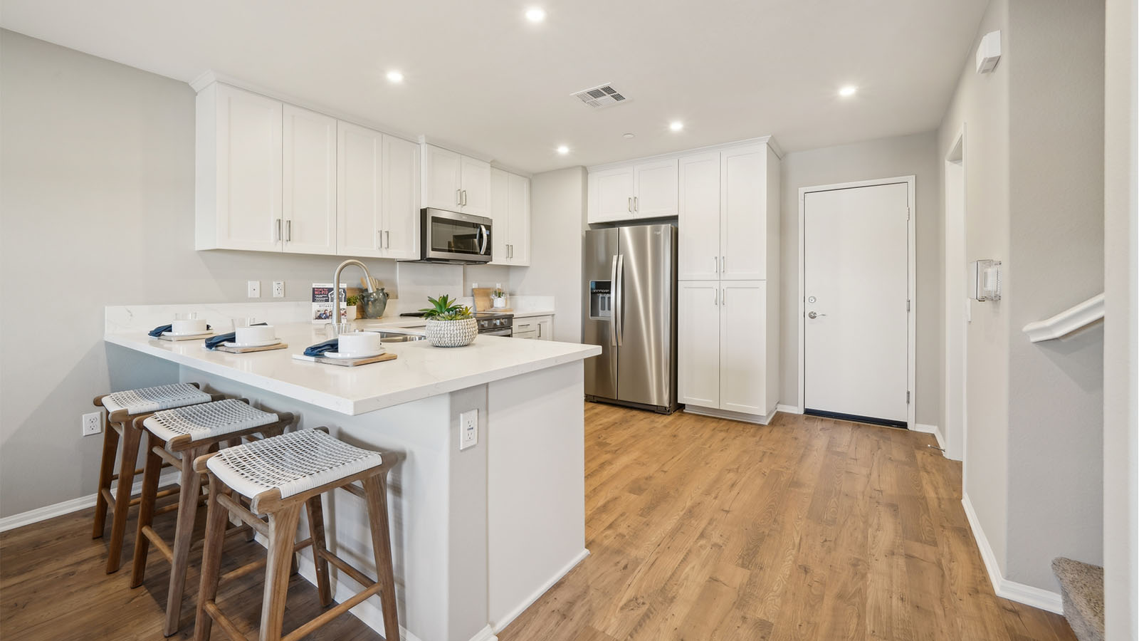 Open-concept kitchen with white cabinets