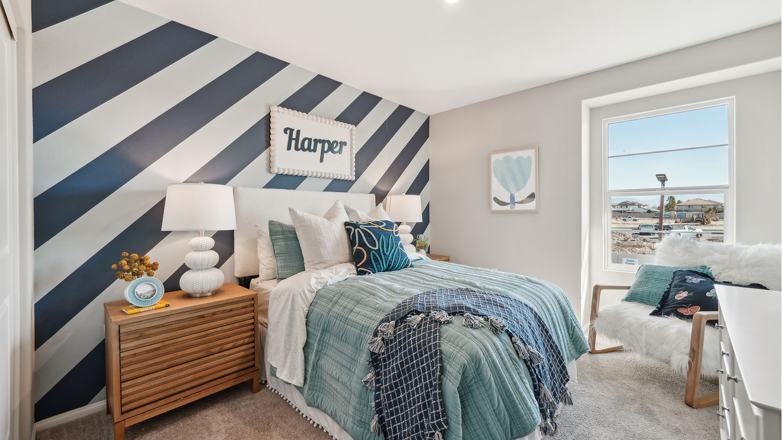 Bedroom with twin bed, accent wall, and plush carpet