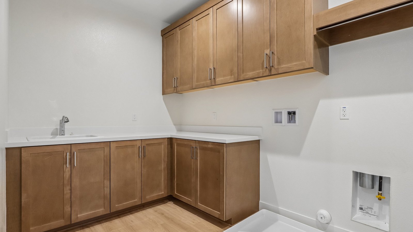 laundry room with cabinets and laundry sink