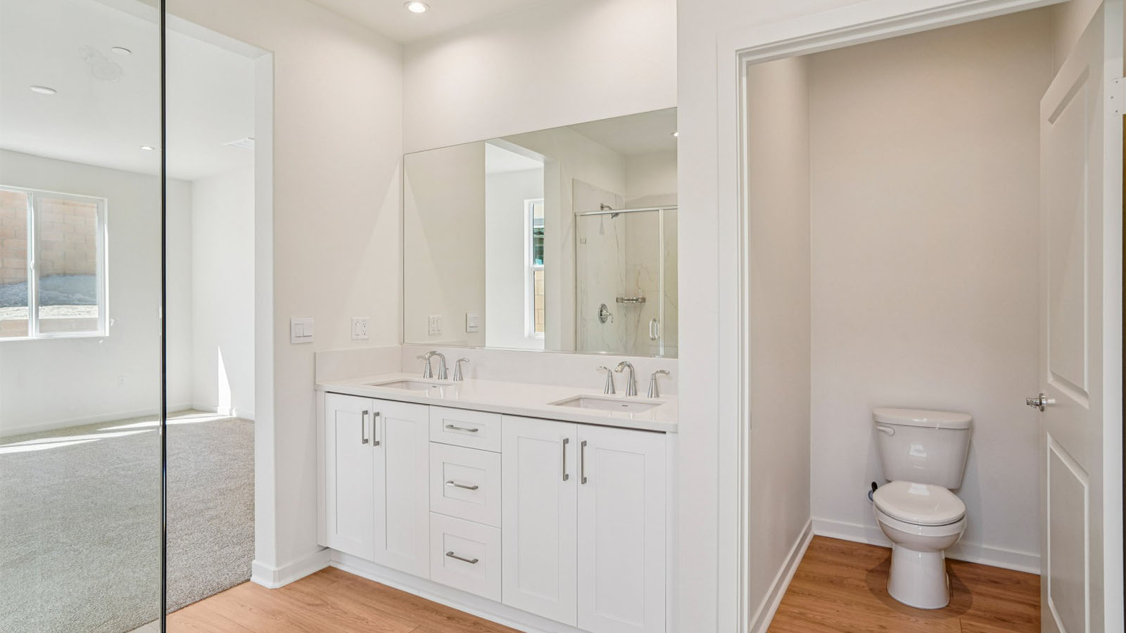 Primary bathroom with dual sinks and shower