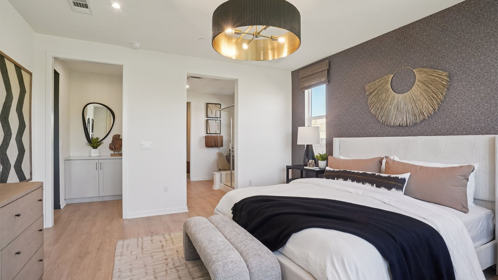 Primary bedroom with king bed and laminate flooring