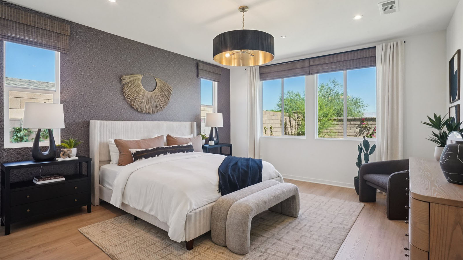 Primary bedroom with king bed and laminate flooring