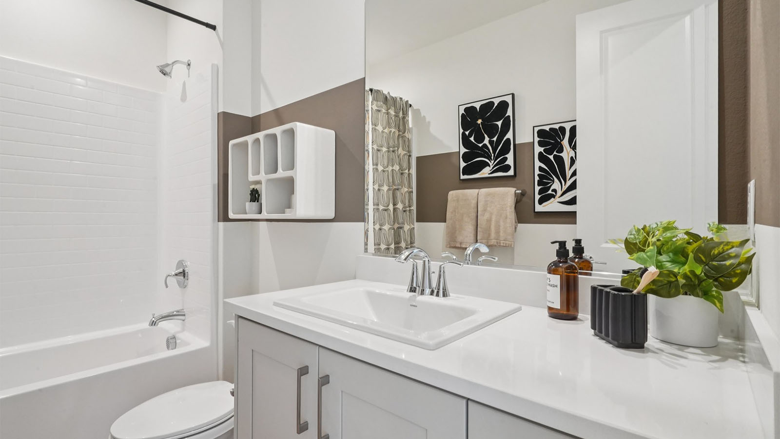 Secondary bathroom with vanity and tub shower combination